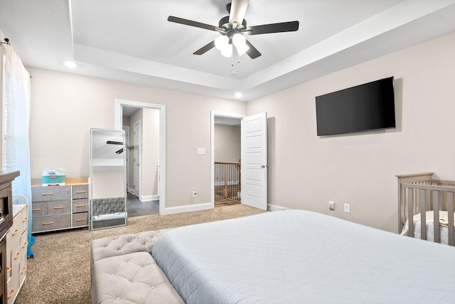 bedroom with carpet and a tray ceiling