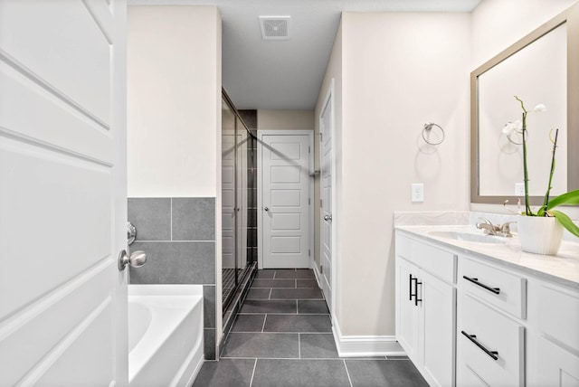 bathroom with tile patterned flooring, vanity, and independent shower and bath