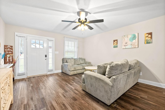 living room featuring ceiling fan and dark hardwood / wood-style flooring