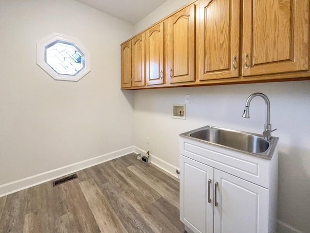 laundry room featuring cabinets, washer hookup, dark hardwood / wood-style floors, and sink