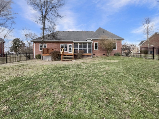 back of house featuring a sunroom, a deck, and a lawn