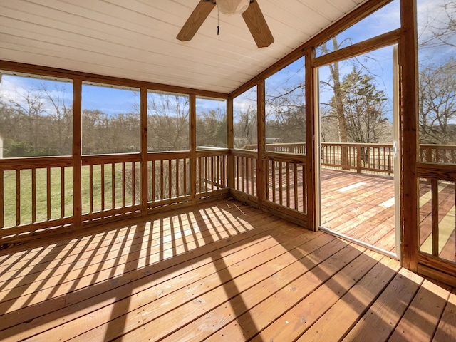 unfurnished sunroom featuring ceiling fan