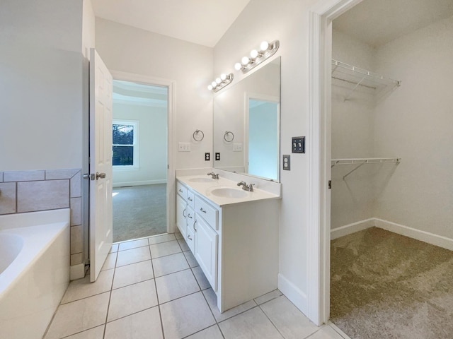 bathroom featuring tile patterned flooring, vanity, and a bathtub