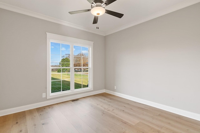 empty room with light hardwood / wood-style flooring, ornamental molding, and ceiling fan