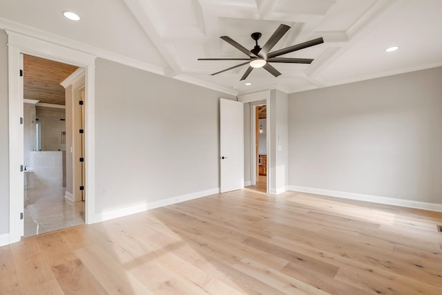 empty room featuring coffered ceiling, crown molding, light wood-type flooring, beamed ceiling, and ceiling fan