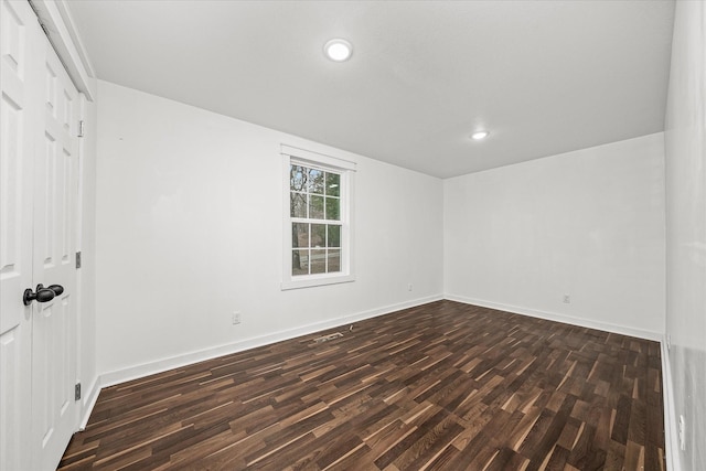 unfurnished room featuring dark hardwood / wood-style flooring