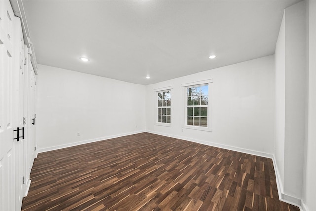 unfurnished room featuring dark hardwood / wood-style flooring