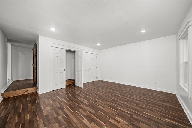 unfurnished bedroom with dark hardwood / wood-style floors
