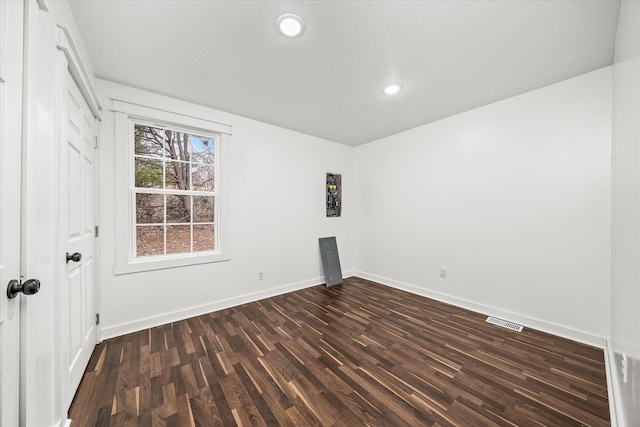 empty room featuring dark hardwood / wood-style floors