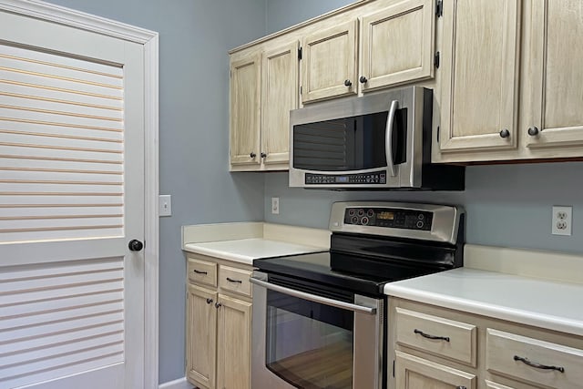 kitchen with stainless steel appliances and light brown cabinets