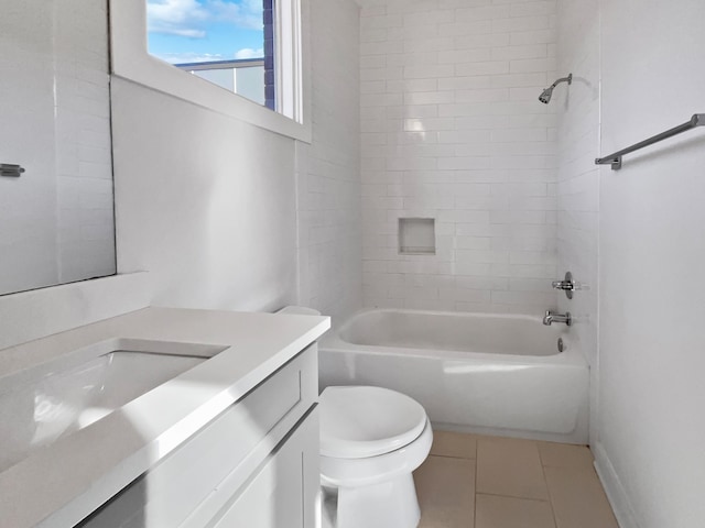 full bathroom with vanity, tile patterned floors, toilet, and tiled shower / bath