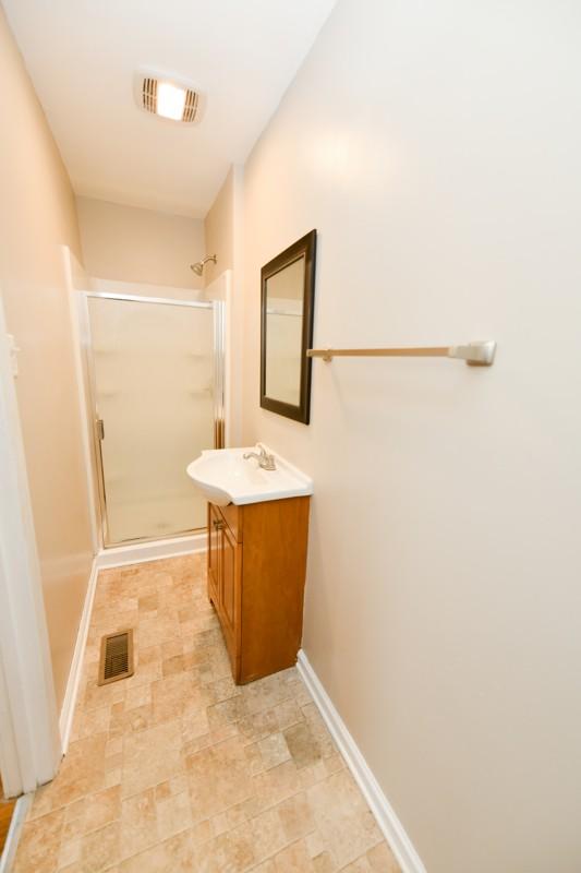 118 Rainbow St, Clarksville, TN 37042 - full bathroom featuring a shower stall, visible vents, baseboards, and vanity
