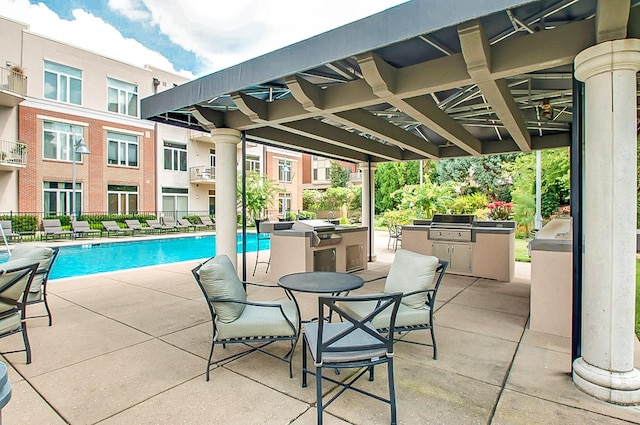 view of pool with a patio area, grilling area, and an outdoor kitchen