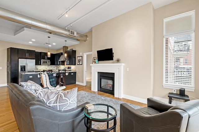 living room featuring track lighting and light hardwood / wood-style floors