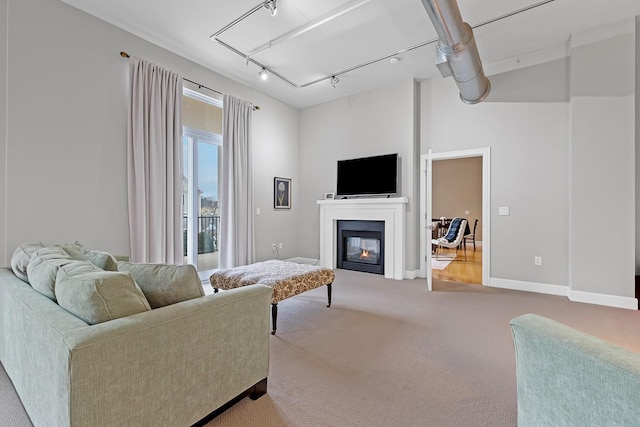 living room with rail lighting and carpet flooring