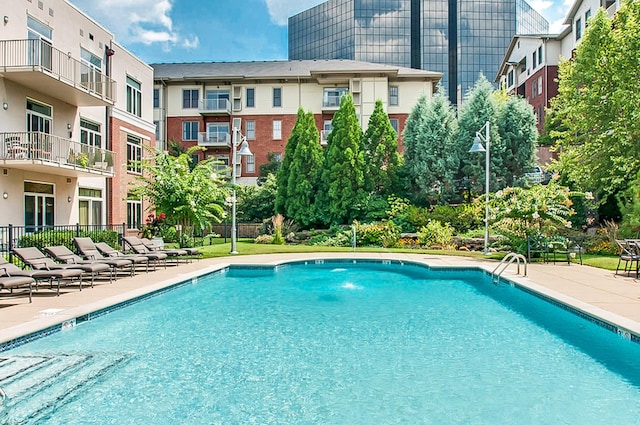 view of pool featuring pool water feature and a patio area