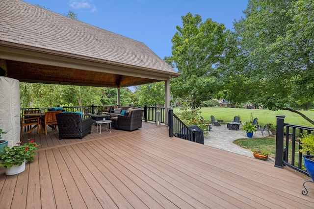 wooden deck featuring a patio area and an outdoor living space with a fire pit