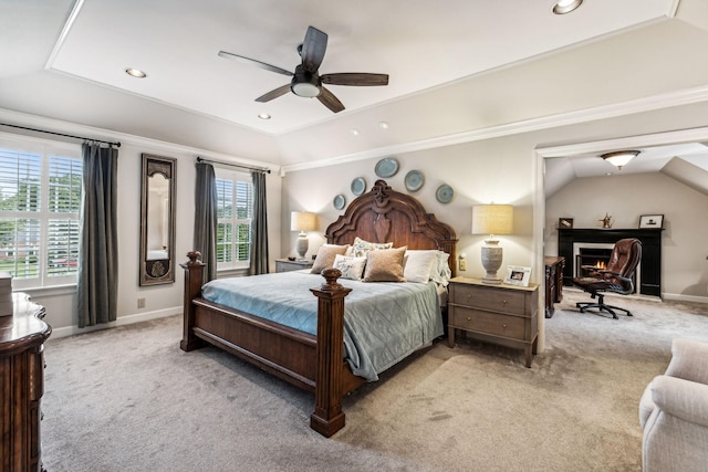 carpeted bedroom with crown molding, vaulted ceiling, and ceiling fan