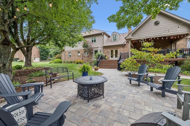 view of patio with a deck and an outdoor fire pit