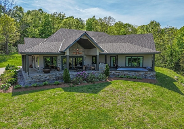 view of front of house featuring a front lawn and a patio area