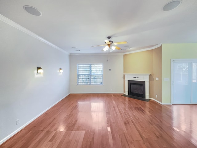 unfurnished living room with crown molding, wood-type flooring, and ceiling fan