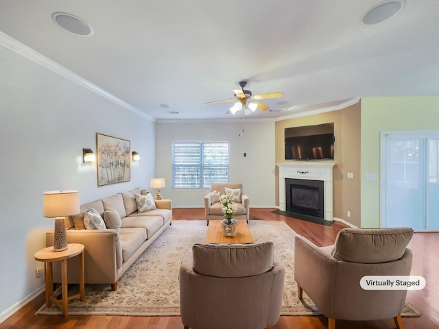 living room featuring crown molding, ceiling fan, and light wood-type flooring