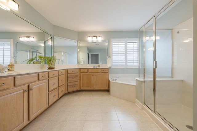 bathroom with tile patterned floors, vanity, and separate shower and tub