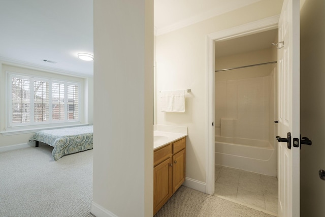 bathroom with tile patterned flooring, vanity, and  shower combination