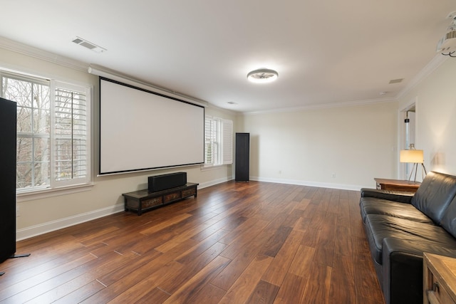 home theater room featuring ornamental molding and dark hardwood / wood-style flooring