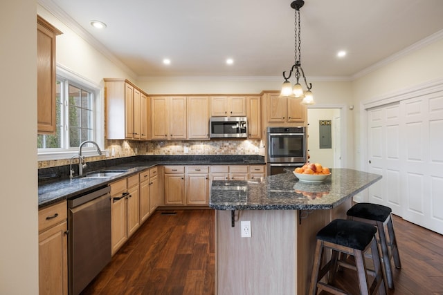 kitchen featuring appliances with stainless steel finishes, dark hardwood / wood-style floors, sink, a center island, and light brown cabinets