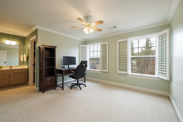 office featuring light carpet, crown molding, and ceiling fan