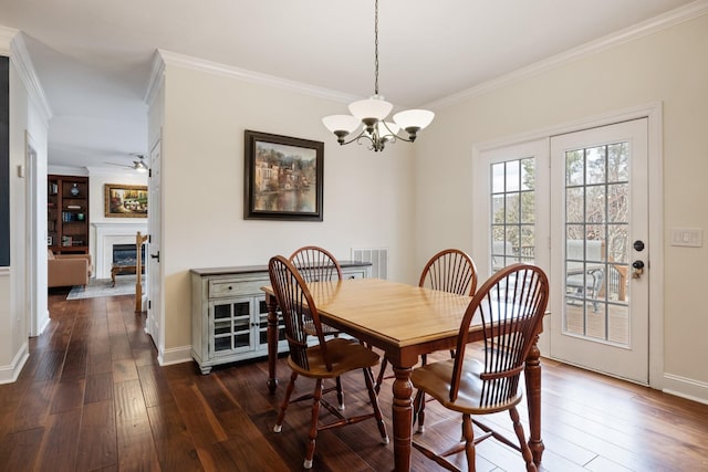 dining room featuring ornamental molding, dark hardwood / wood-style floors, and ceiling fan with notable chandelier