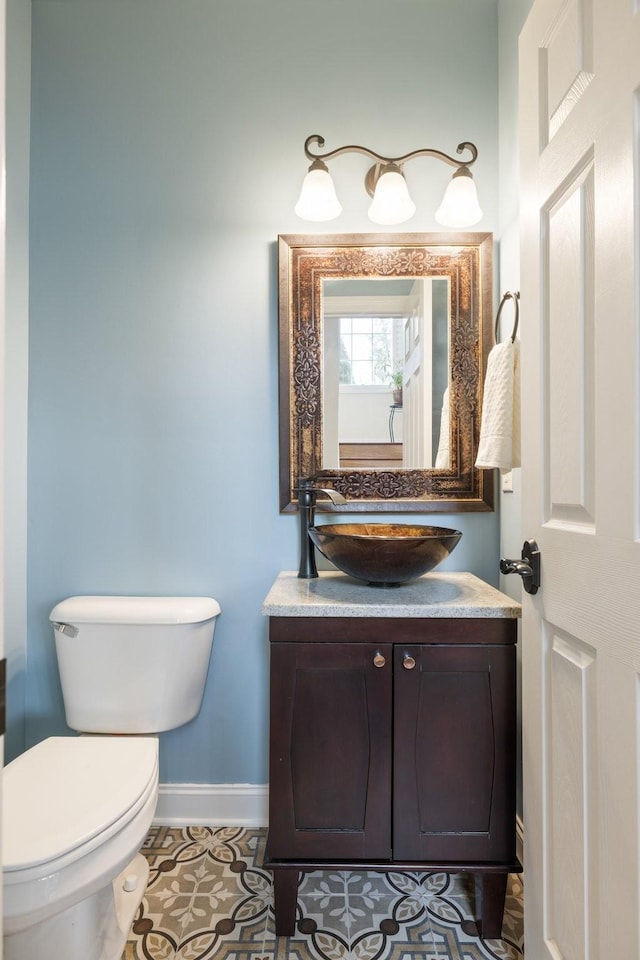 bathroom featuring vanity, toilet, and tile patterned flooring