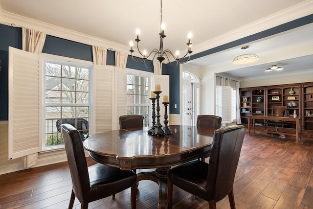 dining area with crown molding, an inviting chandelier, and dark hardwood / wood-style flooring