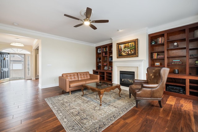 living room with crown molding, dark hardwood / wood-style floors, and ceiling fan