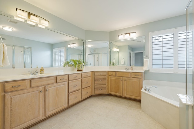 bathroom featuring tile patterned flooring, vanity, and separate shower and tub