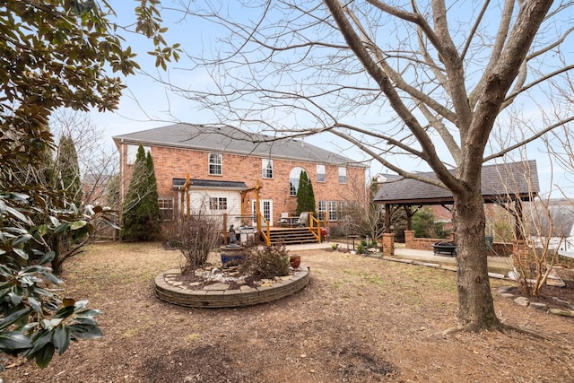 back of property featuring a wooden deck and an outdoor fire pit