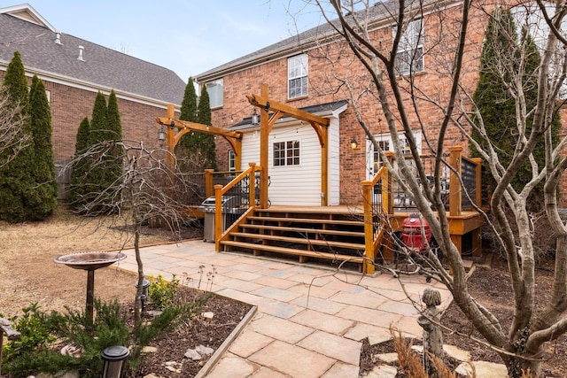 rear view of house with a deck and a patio area