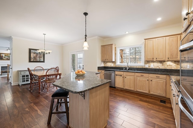 kitchen featuring stainless steel appliances, a kitchen island, hanging light fixtures, and dark hardwood / wood-style flooring