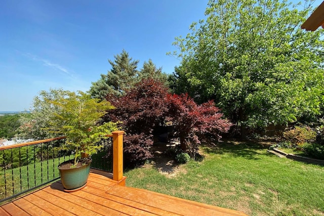 wooden terrace featuring a yard