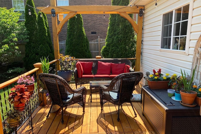 wooden terrace with a pergola and an outdoor hangout area