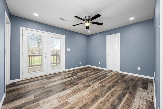 spare room with dark hardwood / wood-style flooring, french doors, and ceiling fan