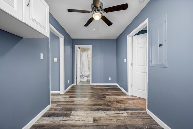 corridor featuring electric panel and dark hardwood / wood-style flooring