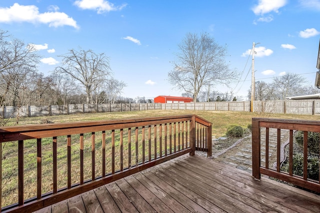 wooden terrace featuring a lawn