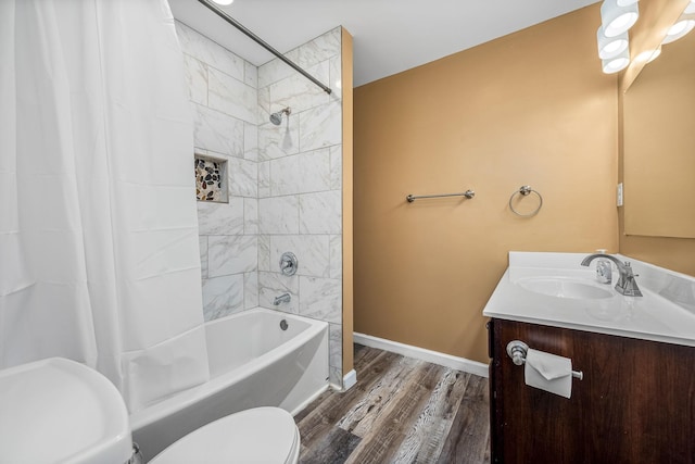 full bathroom with vanity, toilet, hardwood / wood-style floors, and shower / bath combo