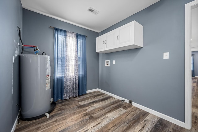 laundry area featuring cabinets, dark hardwood / wood-style floors, hookup for a washing machine, and electric water heater