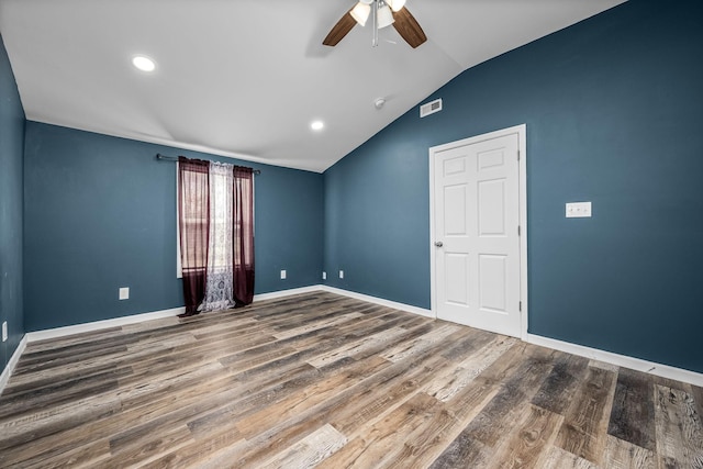 empty room with vaulted ceiling, wood-type flooring, and ceiling fan