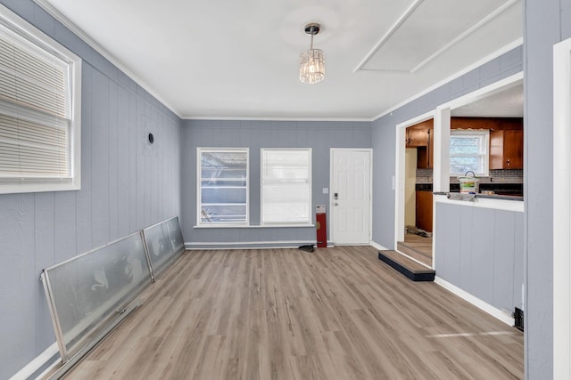 interior space with wood finished floors and crown molding