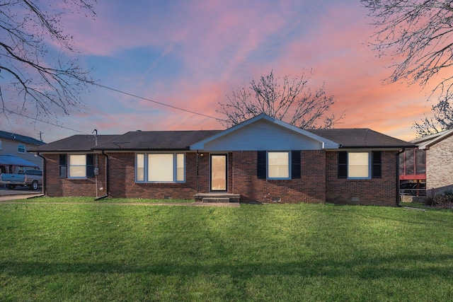 ranch-style house with a yard, brick siding, and crawl space