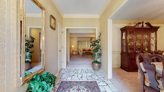 hallway with light carpet and crown molding